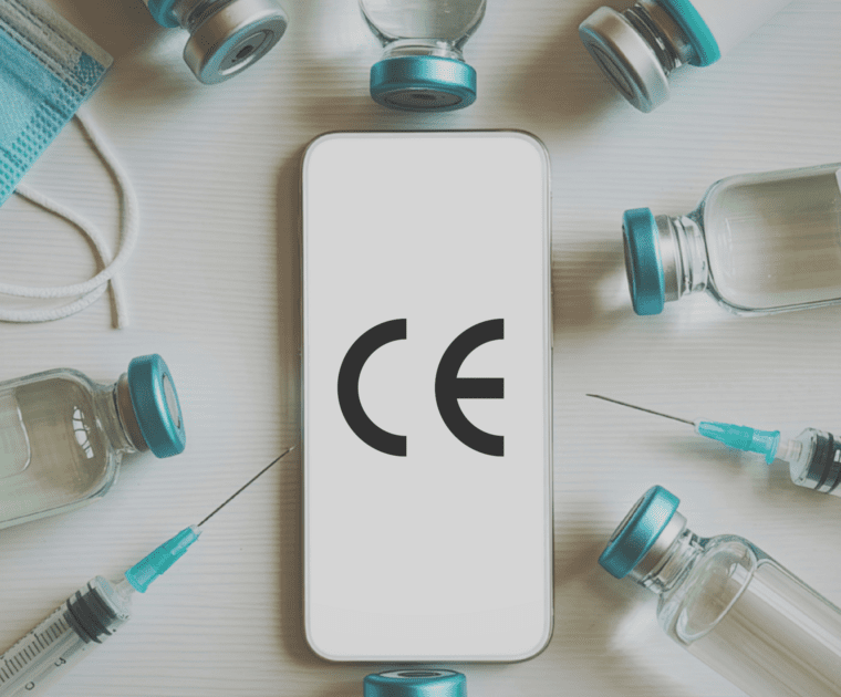 CE marking symbol displayed on a smartphone surrounded by medical devices such as syringes and vials.